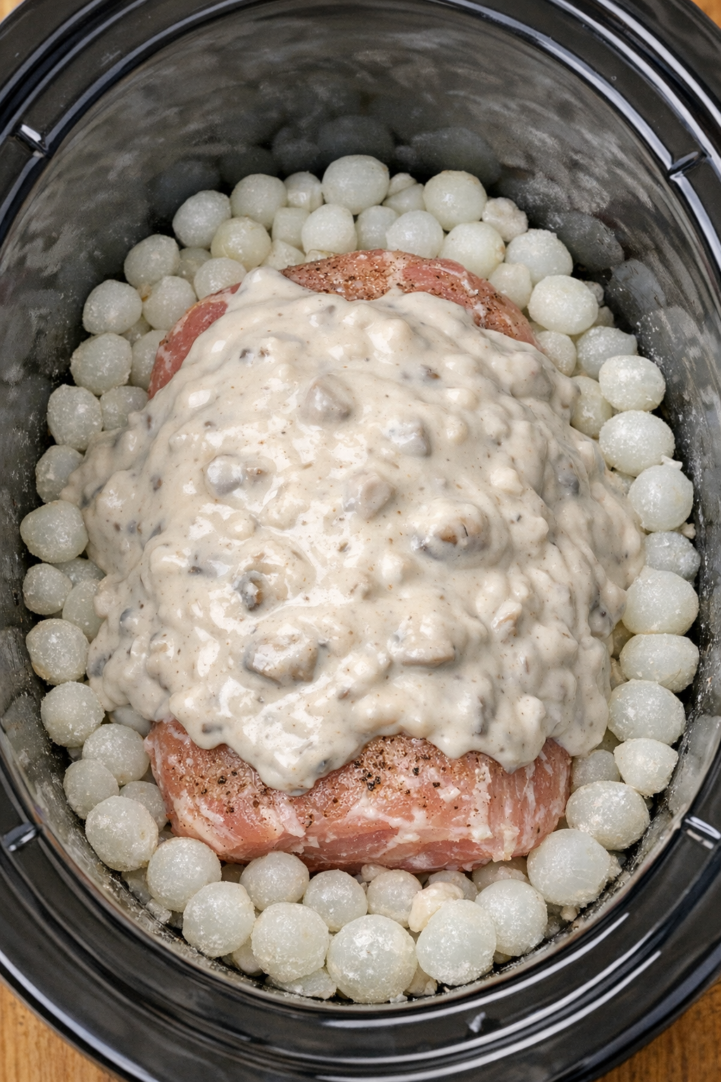 Pork in slow cooker topped with cream of mushroom soup