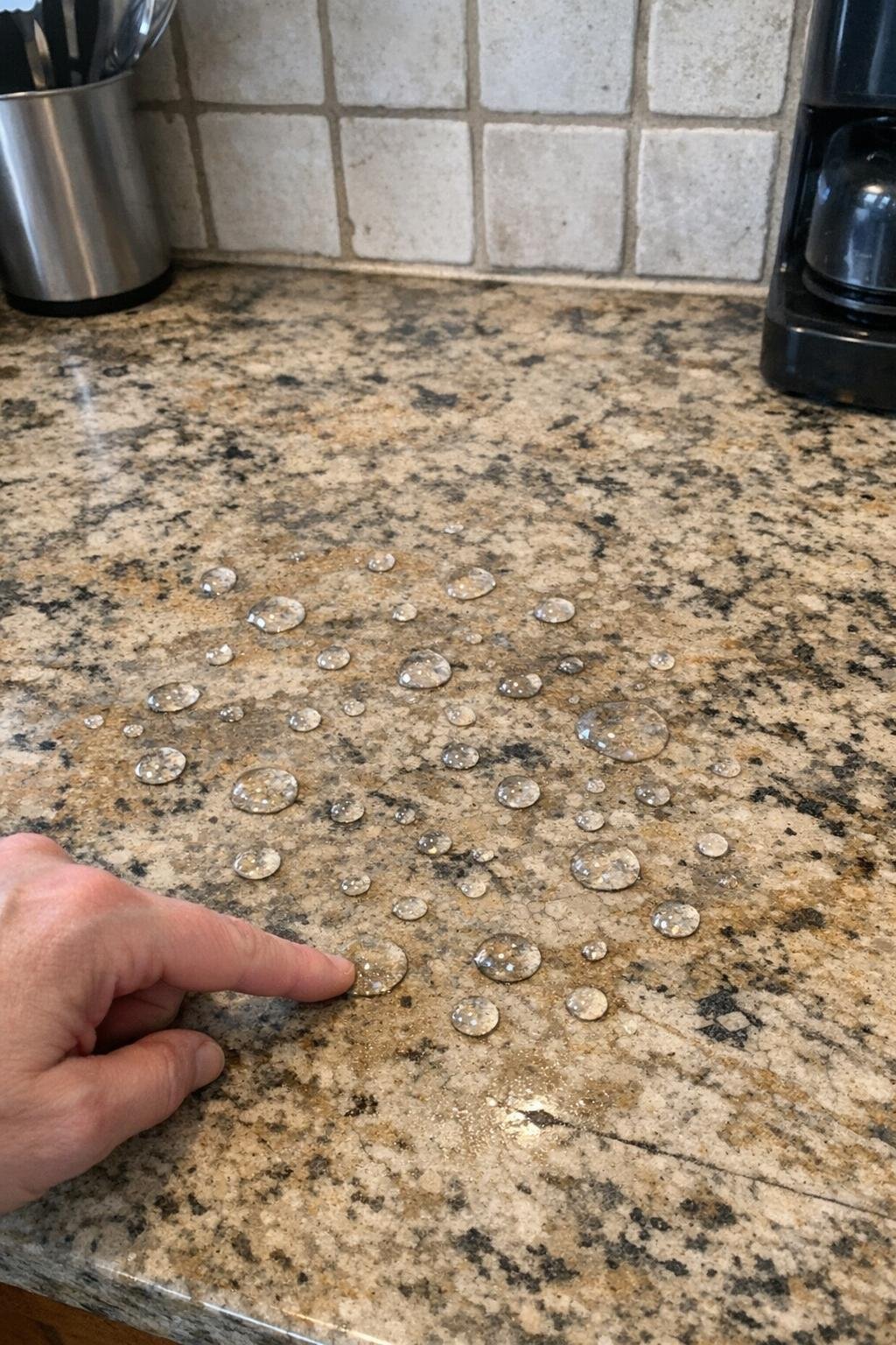 Natural stone countertop with water drops for a sealing test