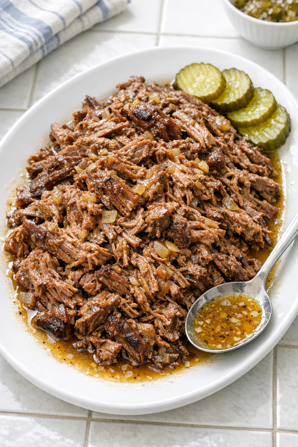 Finished pickle juice beef served on a platter with pickles