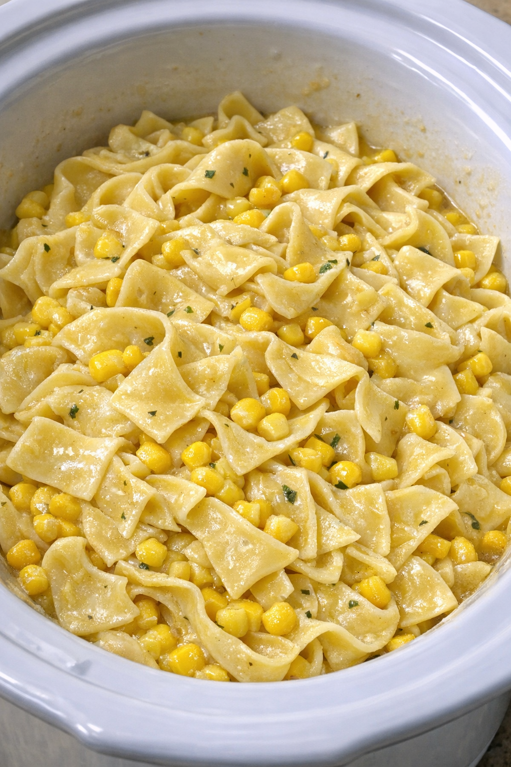 Slow cooker Amish corn noodles in a white slow cooker