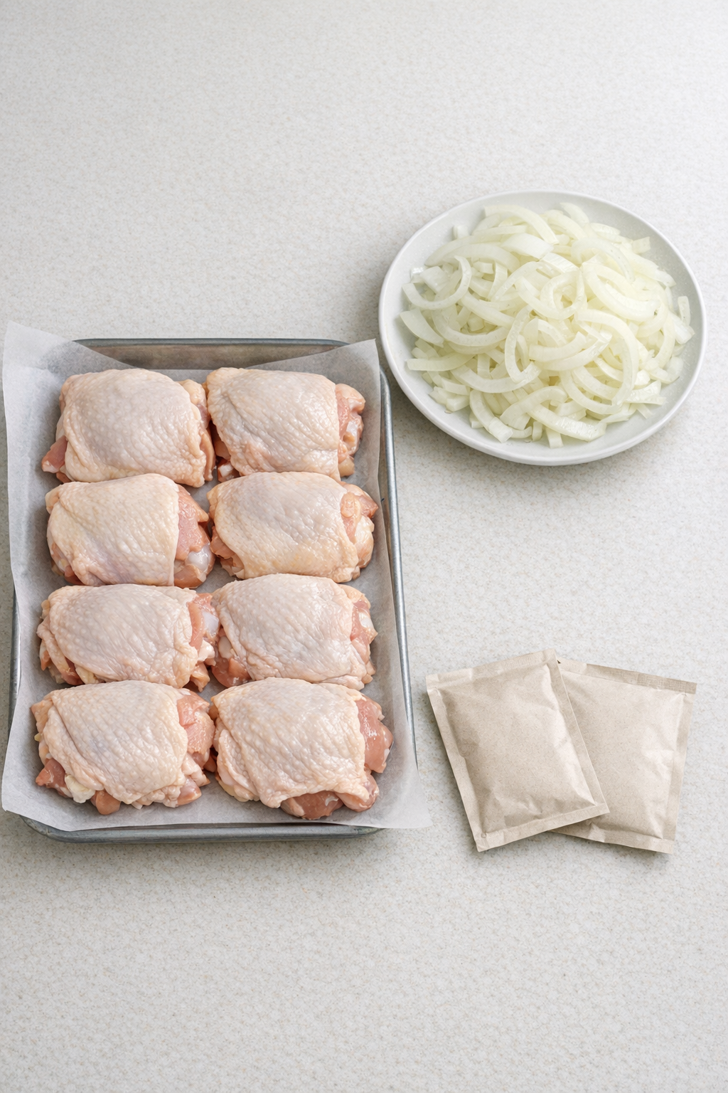 Chicken thighs, sliced onion, and brown gravy mix ingredients