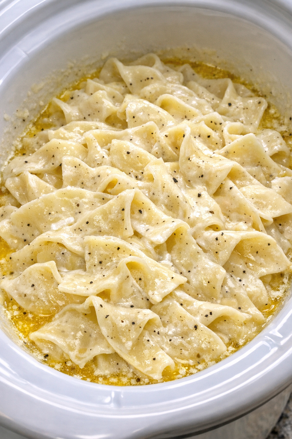 Slow cooker Amish sour cream noodles in a white slow cooker