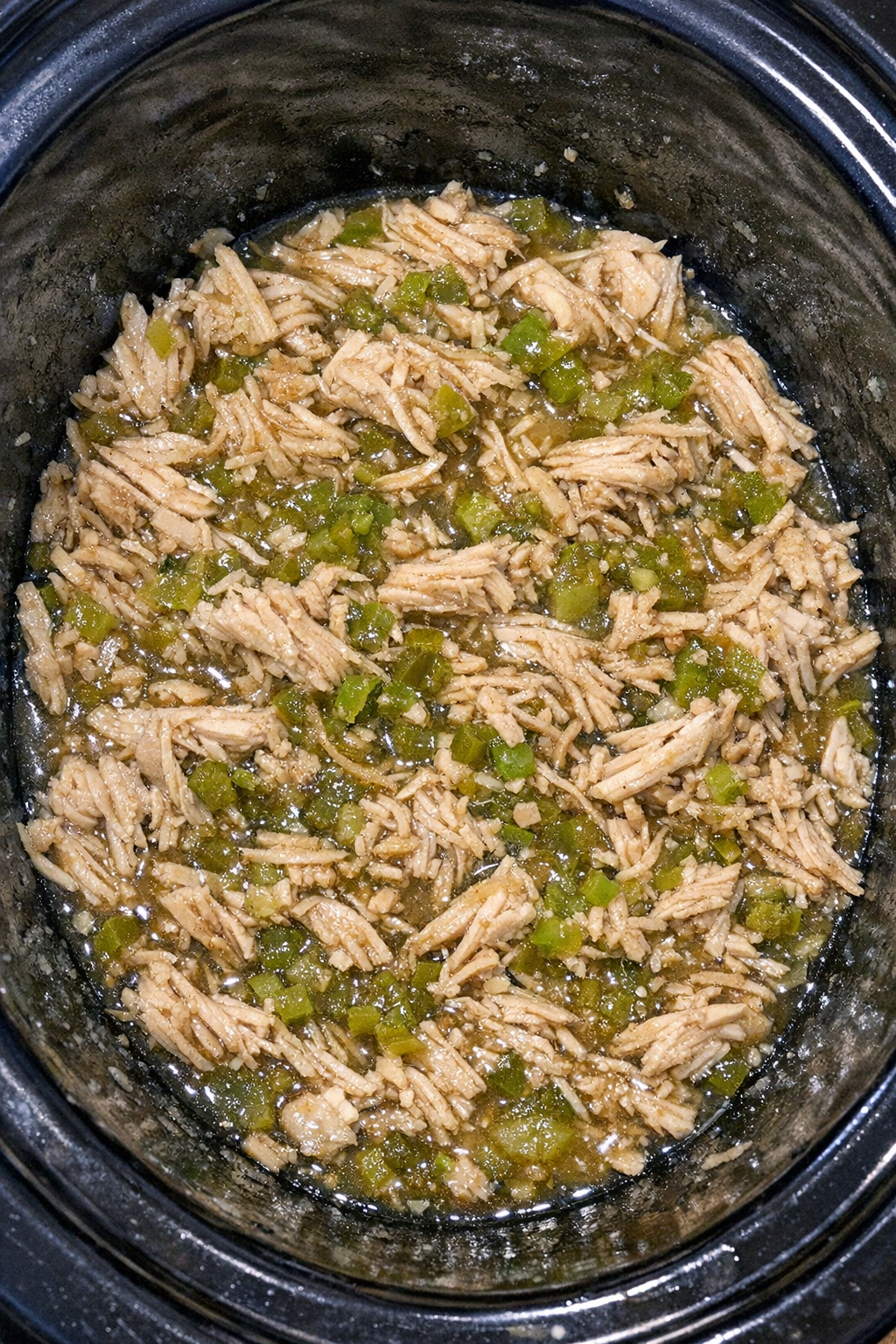 Slow cooker sweet relish chicken in a black slow cooker