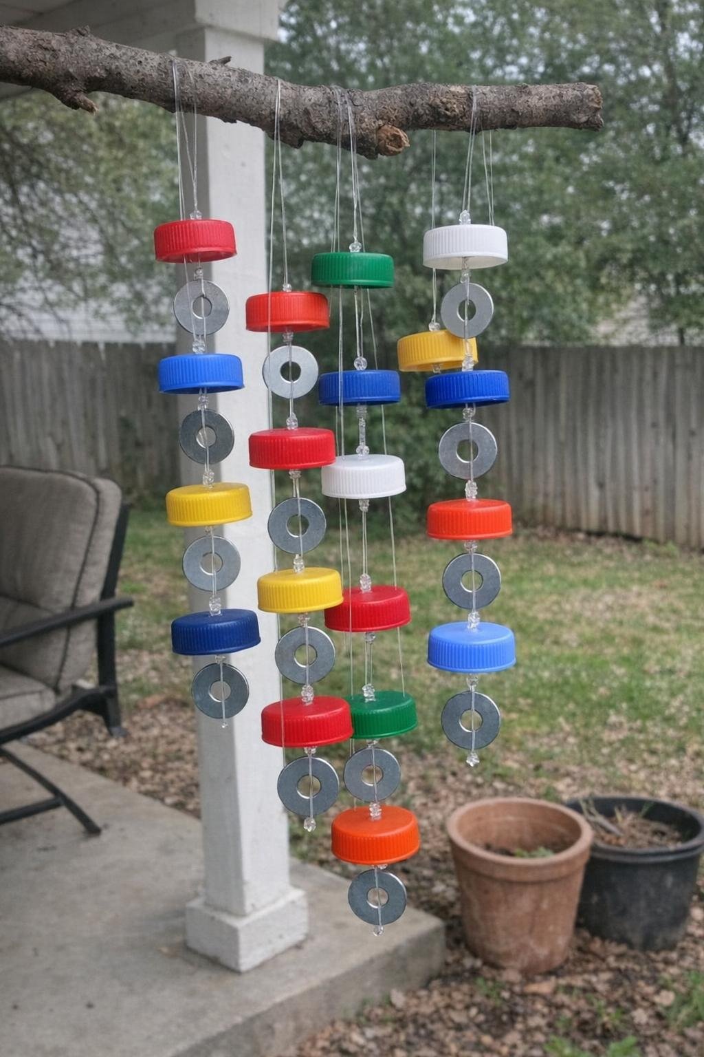 Bottle cap wind chime hanging from a branch